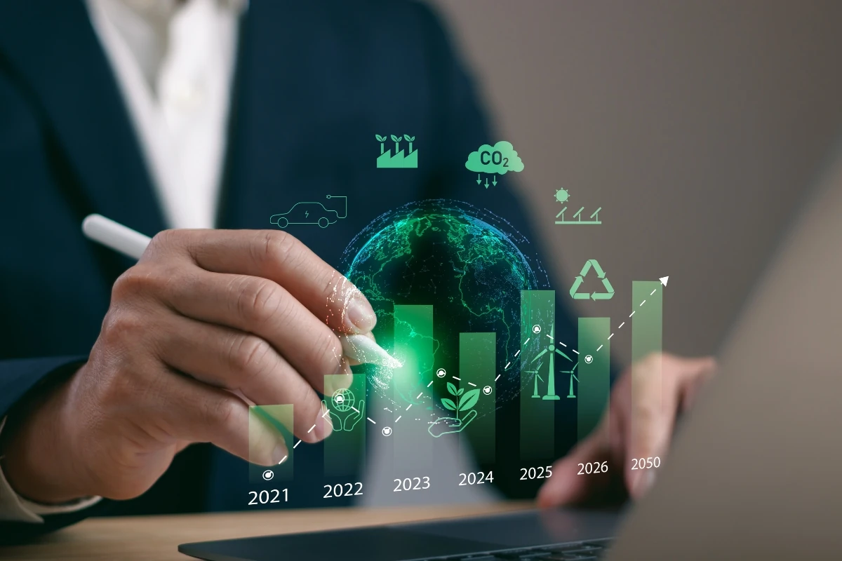 Ilustración conceptual sobre sostenibilidad y transición energética que muestra una persona utilizando un lápiz digital frente a un gráfico de crecimiento con indicadores ambientales, energía renovable, reducción de emisiones de CO₂ y economía circular.